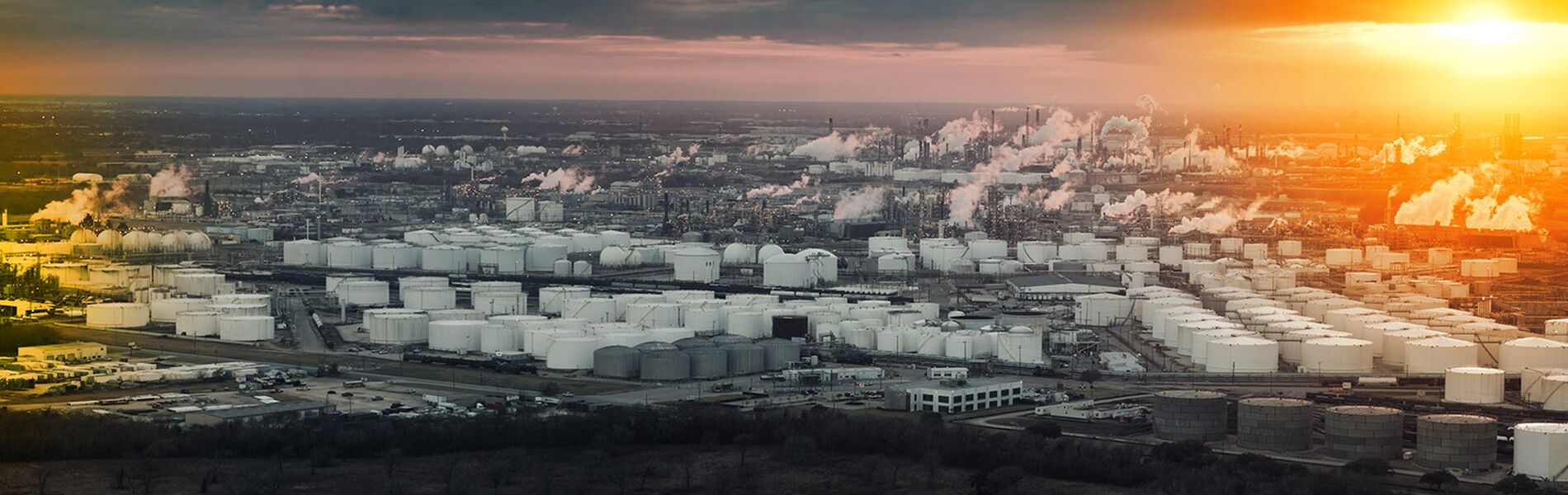Offshore oil and gas industry with piping and valves, worker in foreground