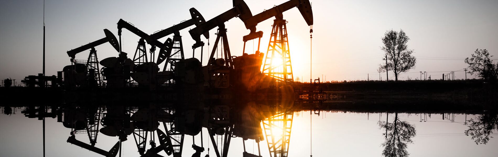 Offshore oil and gas industry with piping and valves, worker in foreground